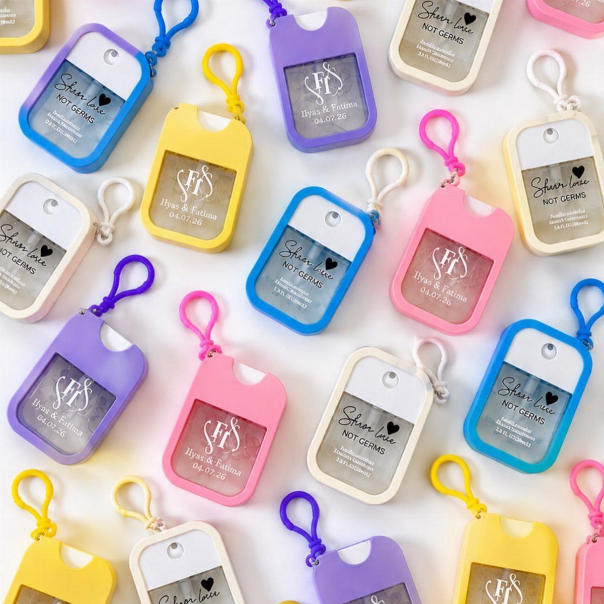 Colorful personalized hand sanitizer bottles with custom labels scattered on a white background.