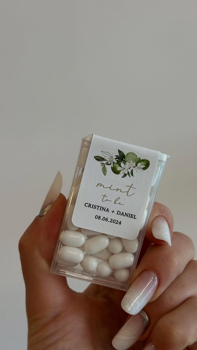 Small clear box of white mints with a personalized wedding favor label.