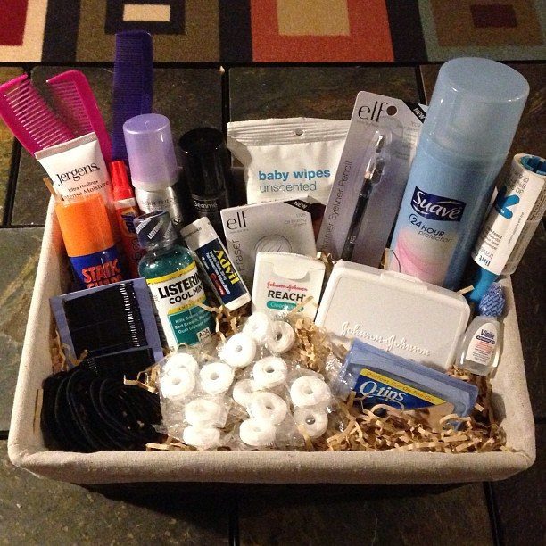 White fabric basket filled with toiletries and grooming supplies on shredded paper filler.