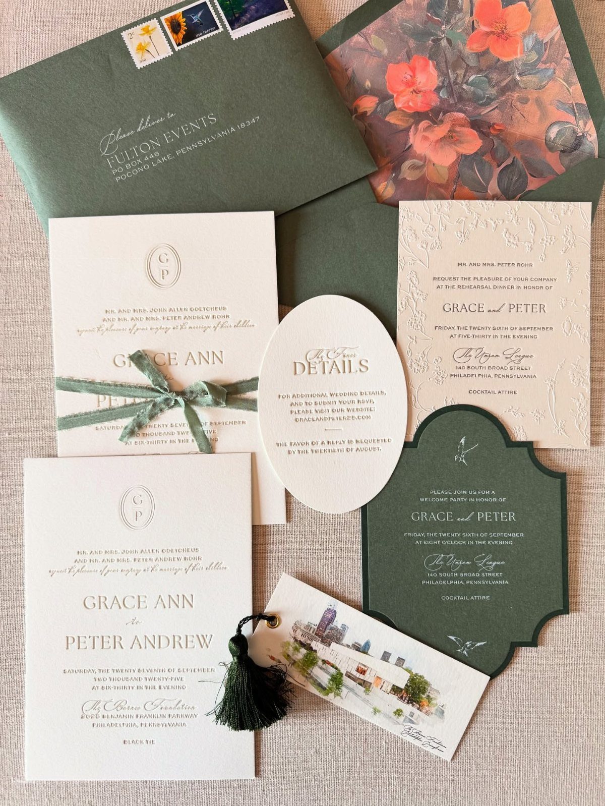 Wedding invitation suite with green envelopes, white cards, and a circular monogram logo.