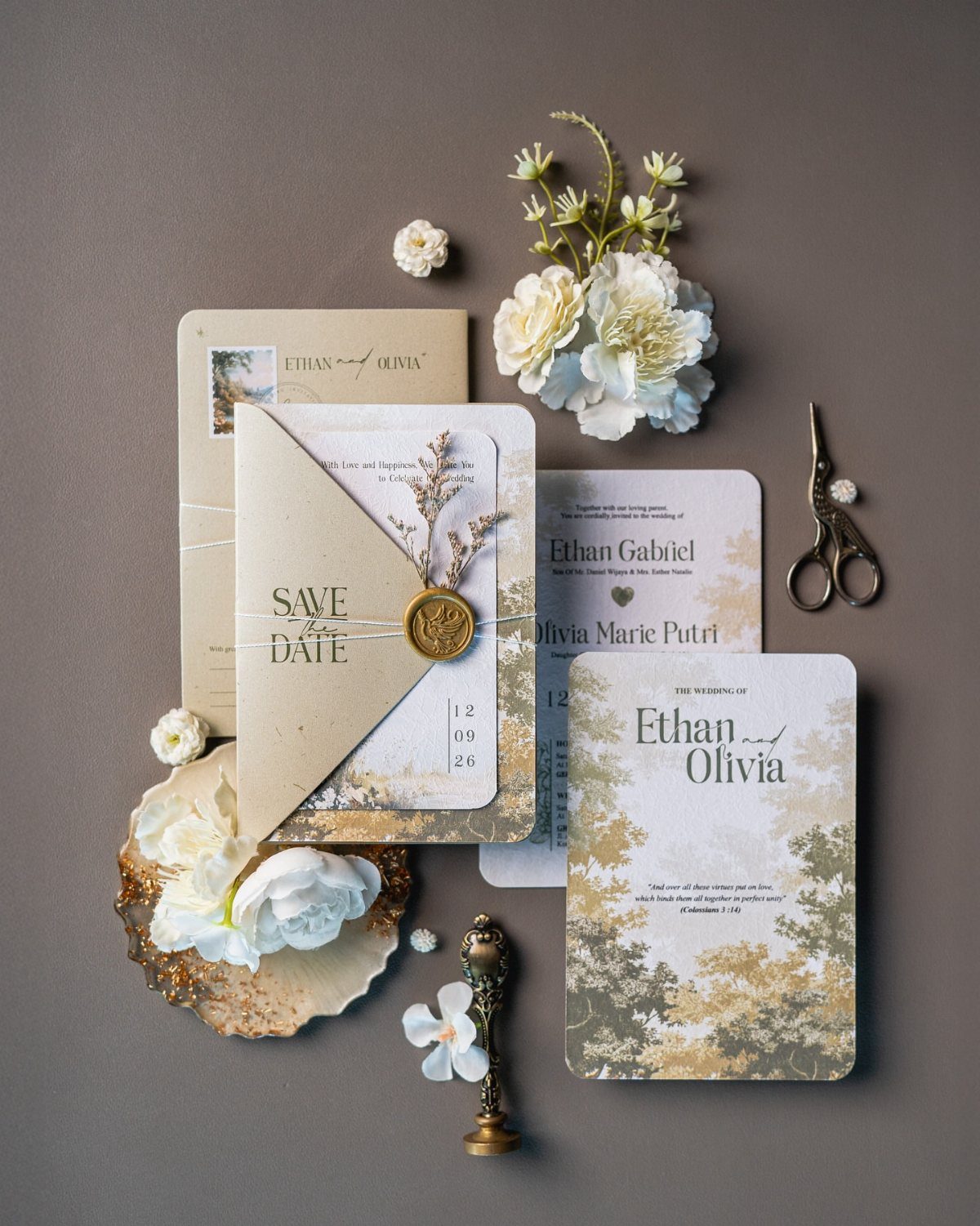 Wedding invitation suite with kraft paper, wax seal, and white floral accents.