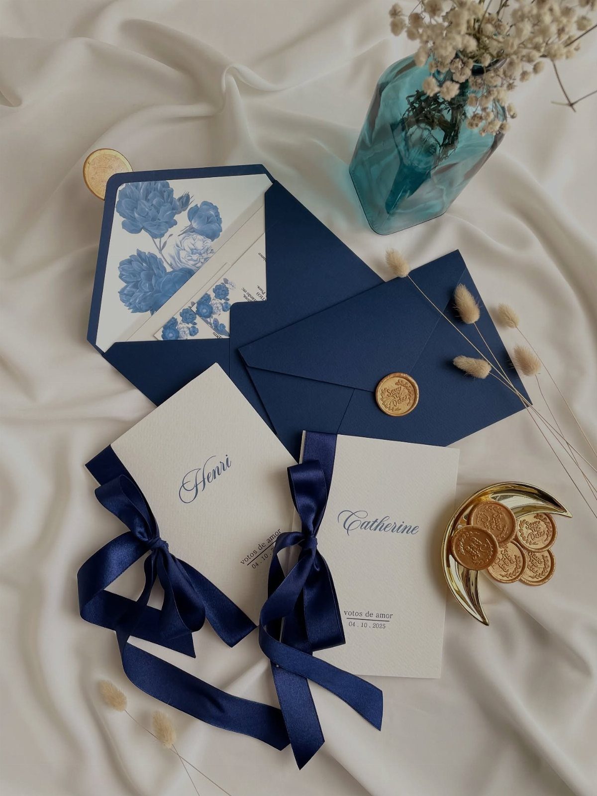 Navy blue and white wedding invitations with gold wax seals and crescent moon decor.