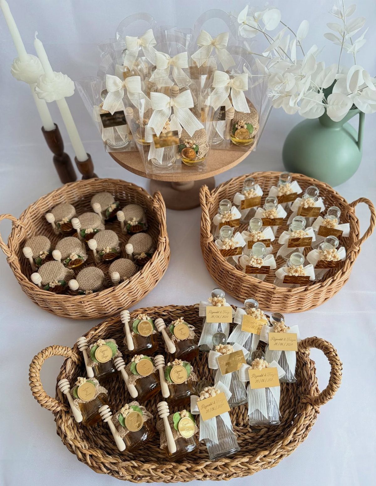 Miniature honey jars with burlap lids and ribbons arranged in woven baskets.