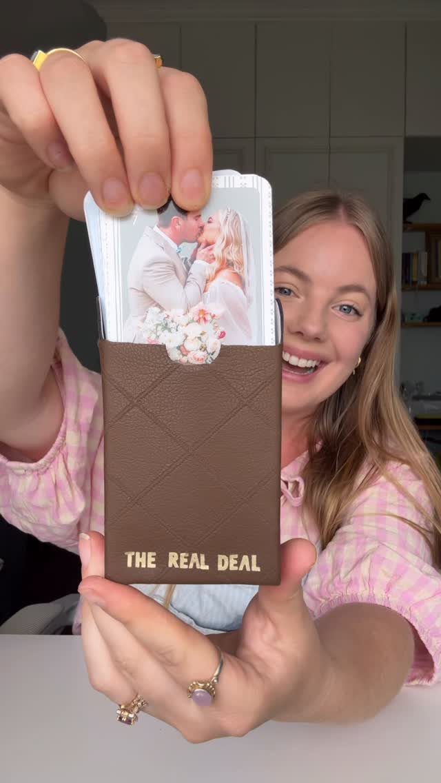 Custom playing cards with a wedding photo in a brown leather holder.