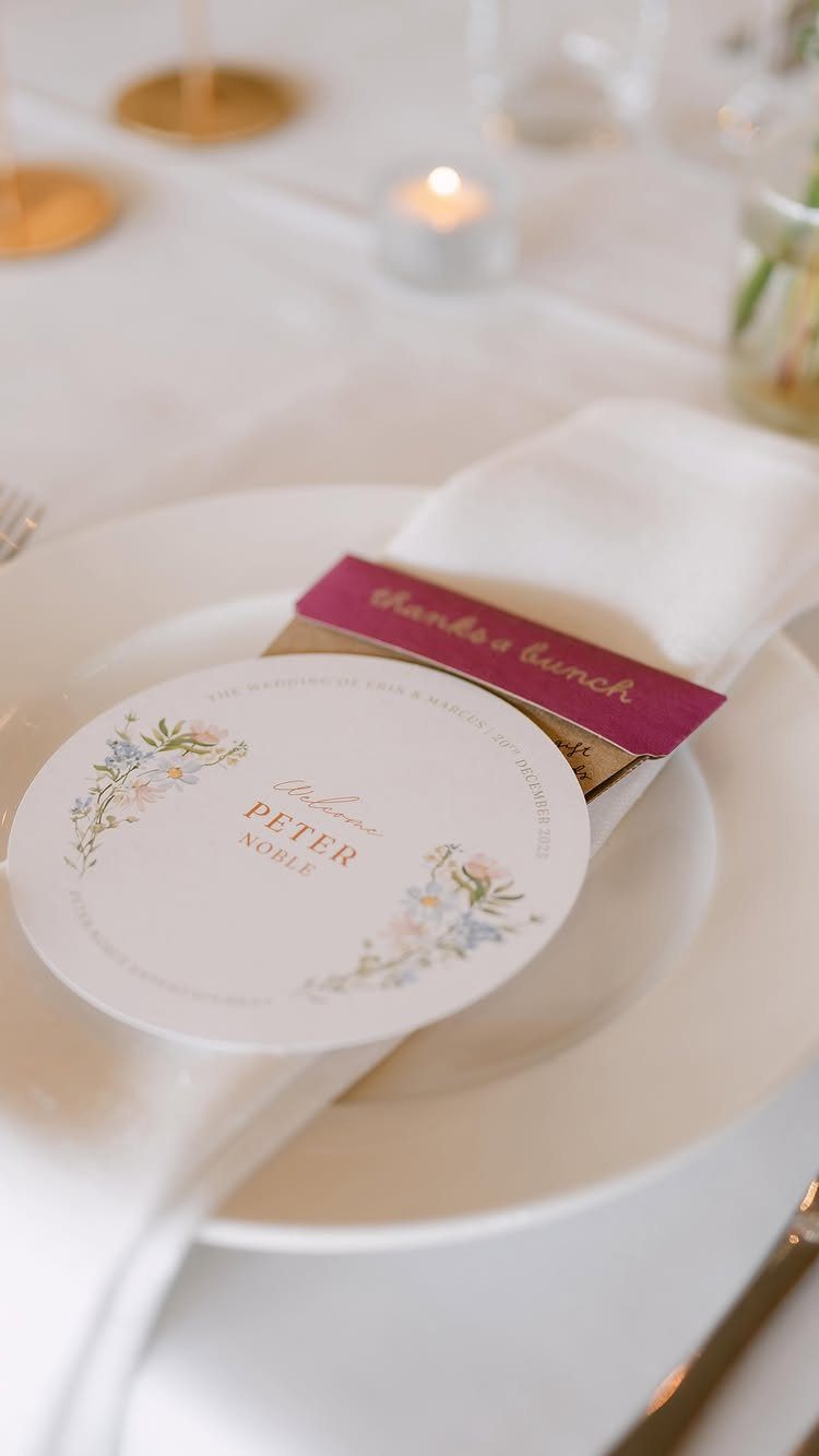 Seed packet with magenta label on a wedding plate with name card