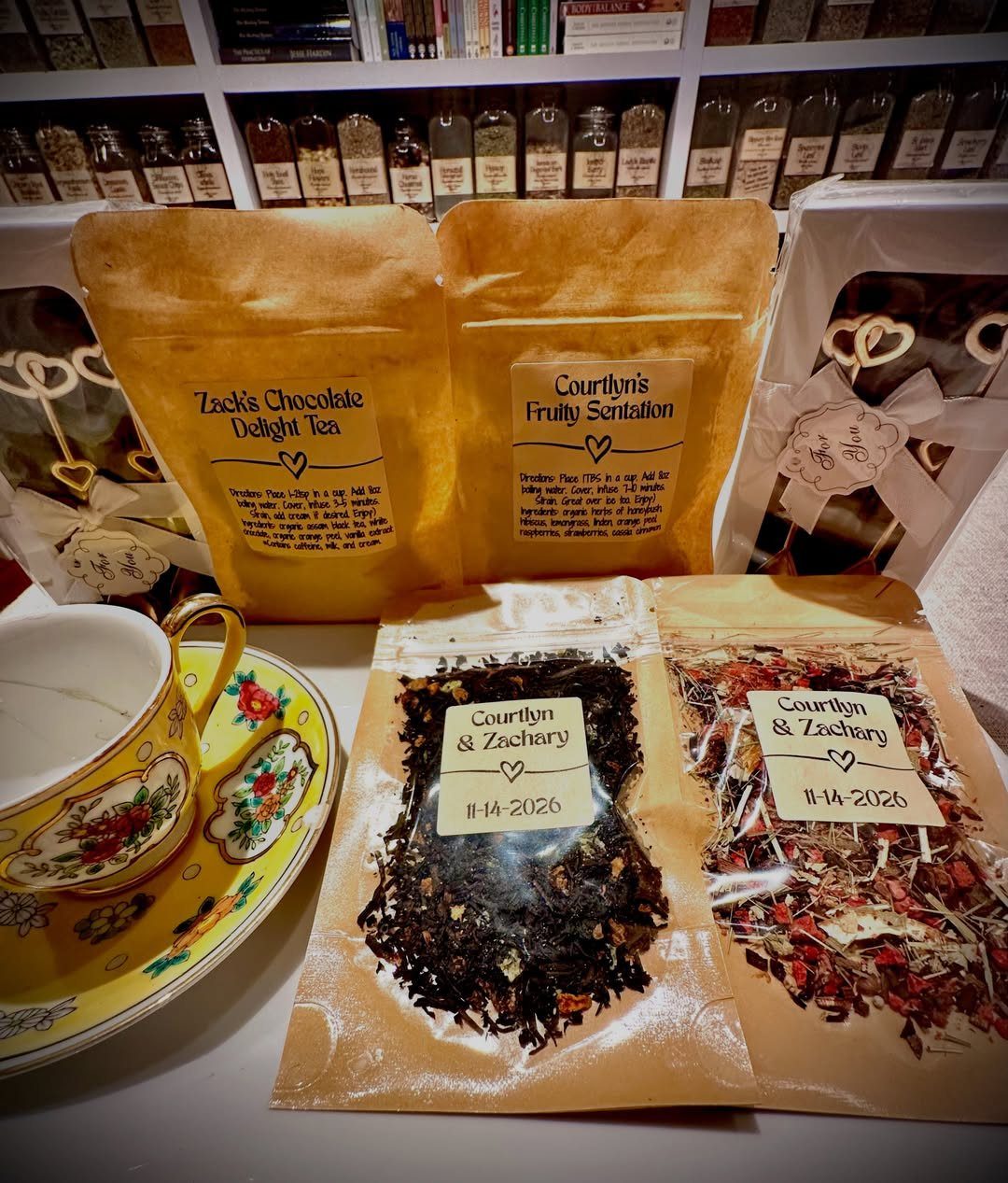 Custom brown paper tea pouches with labels next to a floral teacup