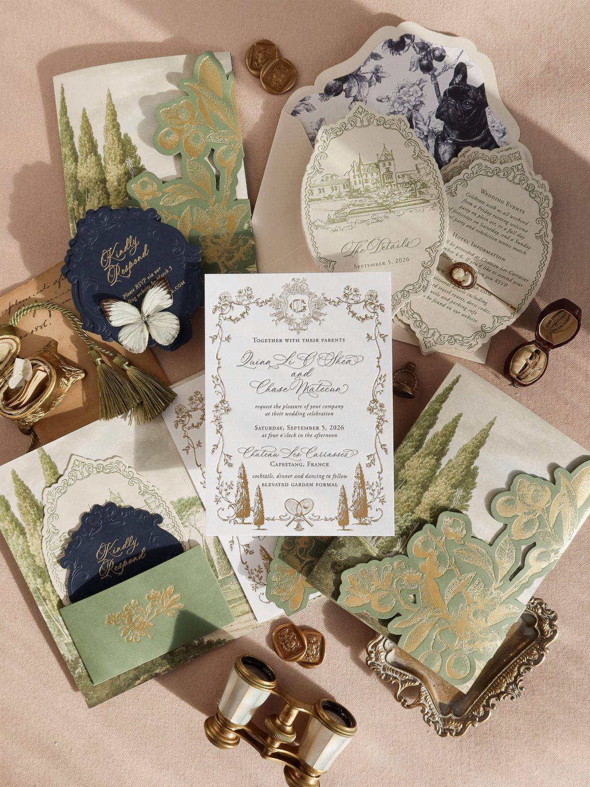 Elegant wedding invitations with gold laser-cut foliage, navy accents, and vintage opera glasses.