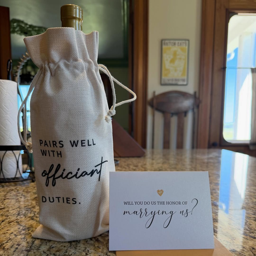 Wine bag for an officiant and a request card on a granite counter