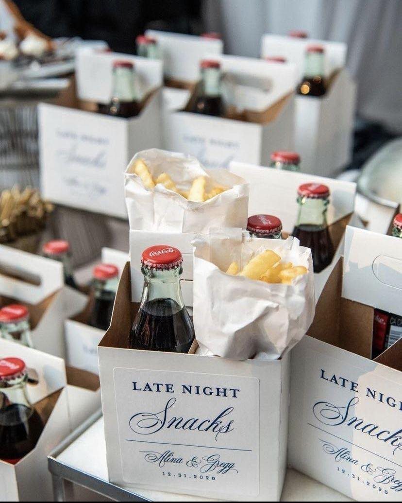Late night snack boxes with cola bottles and french fries for a wedding.