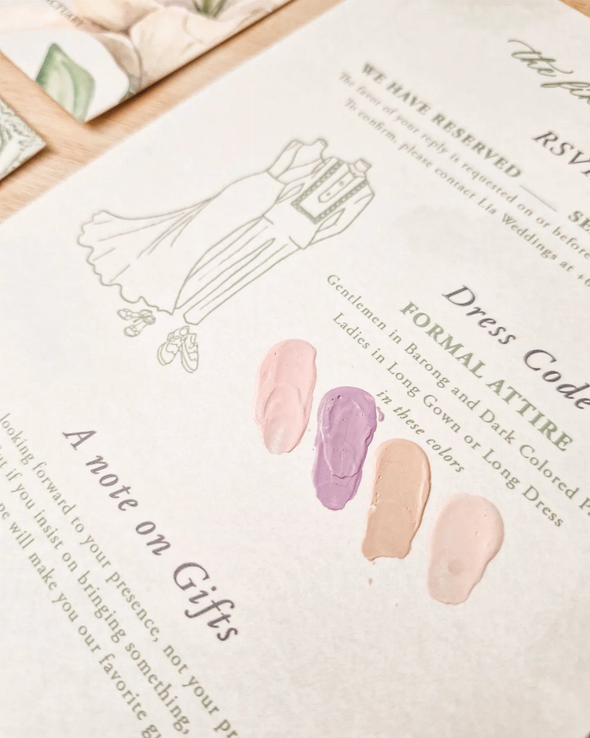 Wedding invitation card showing formal dress code requirements with colorful paint swatches.