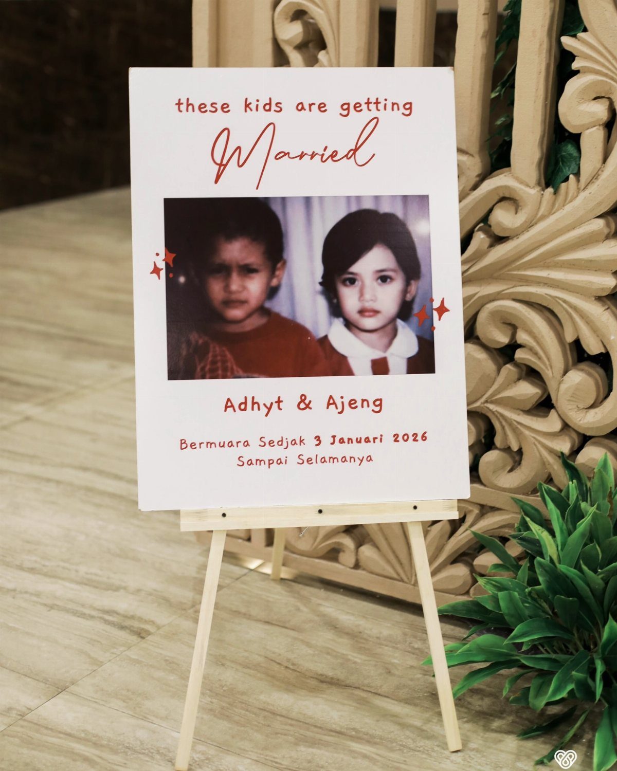 Wedding sign on a wooden easel featuring childhood photos and funny text.