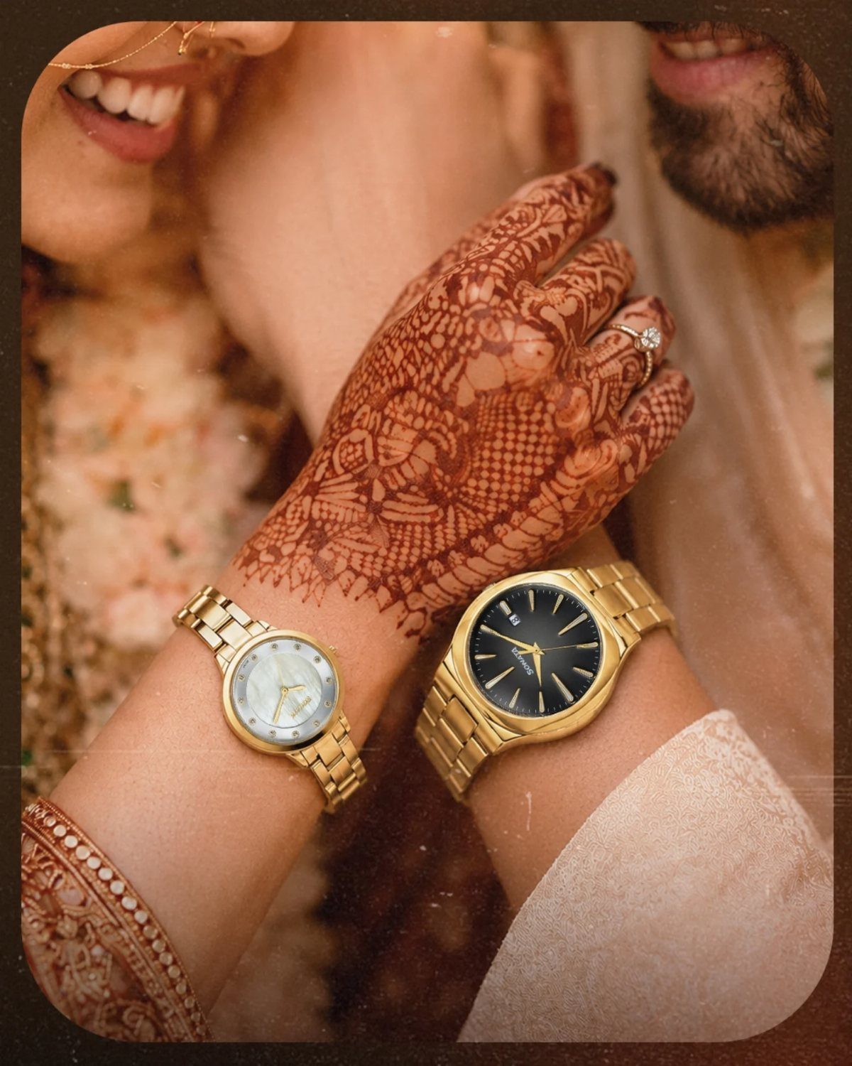Two gold watches on the wrists of a couple in traditional Indian wedding attire