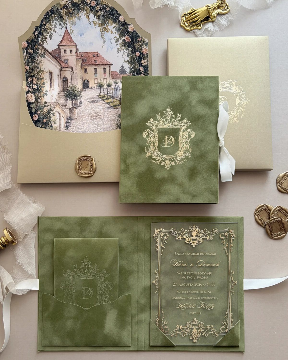 Green wedding invitations with gold foil family crests and a village illustration.