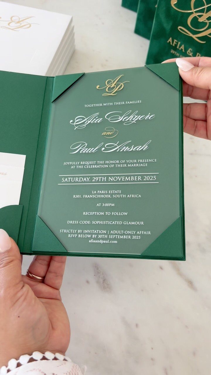 Green wedding invitation with gold cursive text and a custom gold monogram logo.
