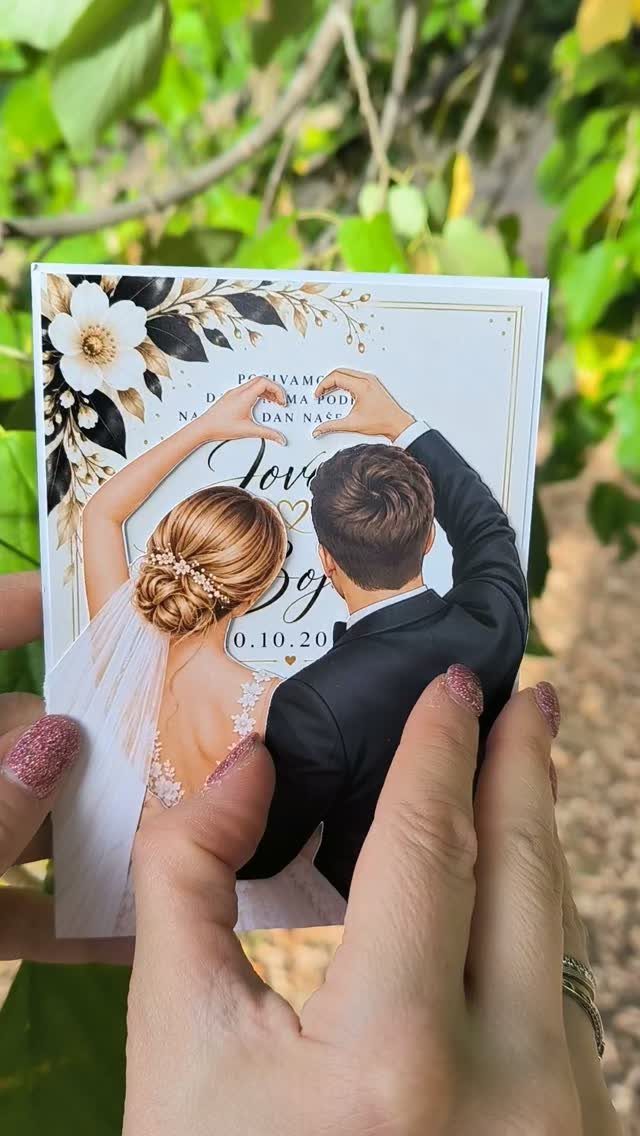 Wedding invitation card showing a bride and groom forming a heart with hands.