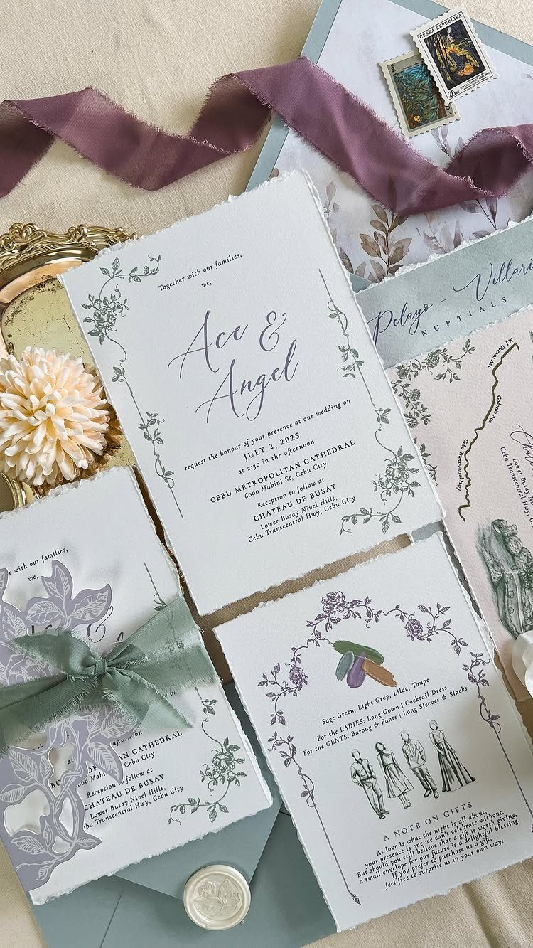 Wedding invitation suite with lavender floral designs, sage green ribbon, and sage envelope.