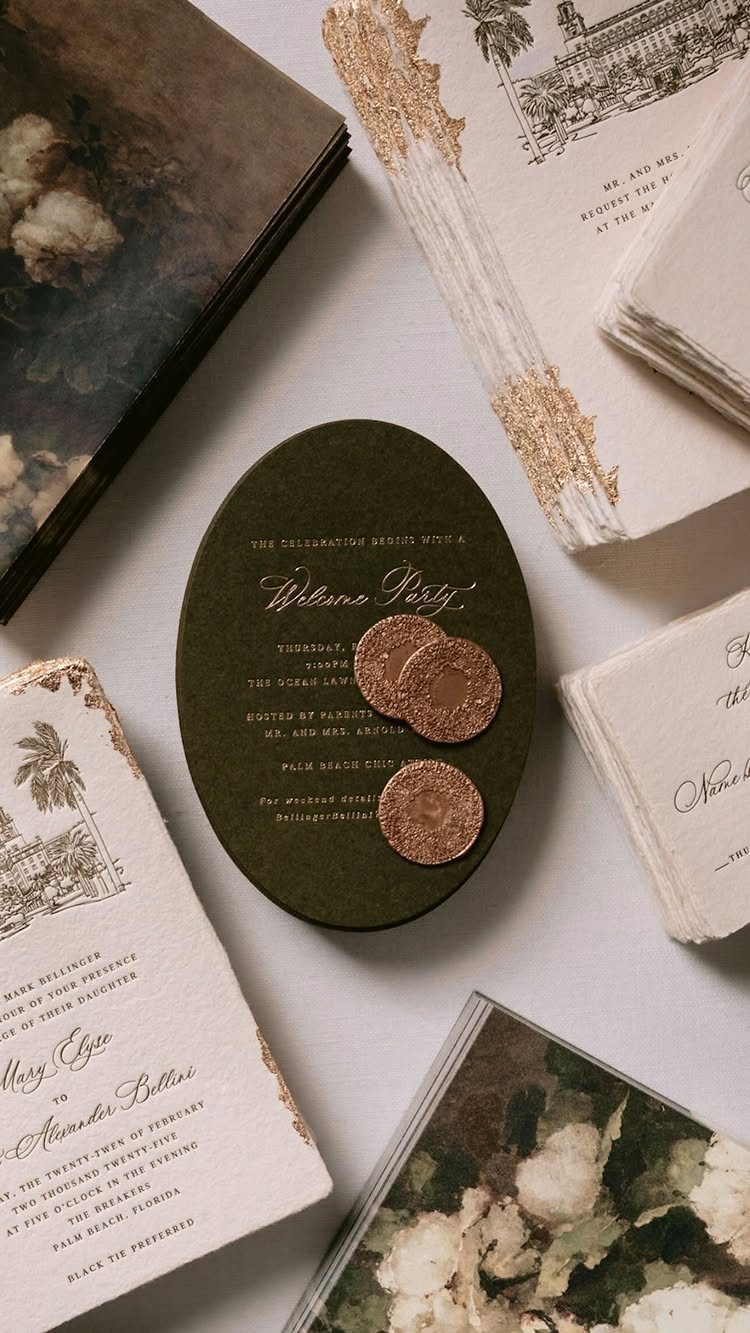 Olive green oval invitation with gold italic lettering and gold wax seals.