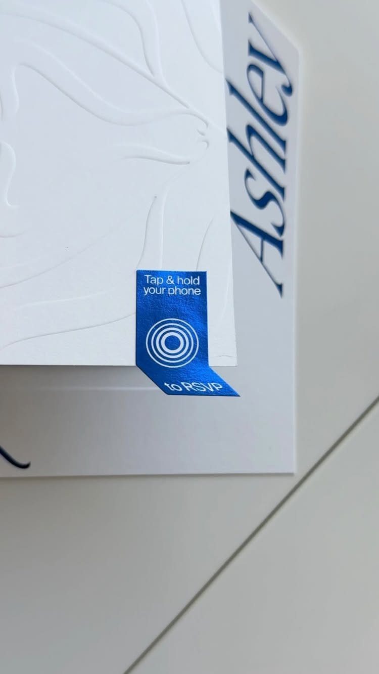 Wedding invitation with a blue NFC sticker for digital RSVP response.