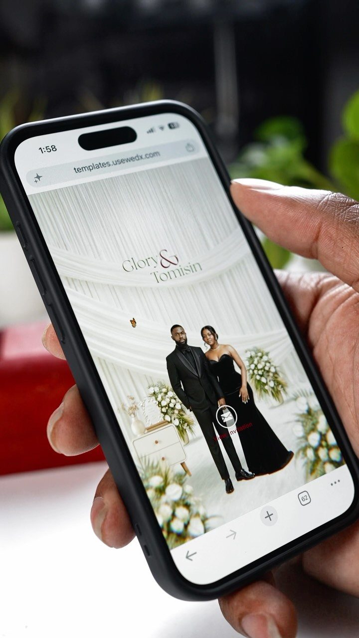 Smartphone screen displaying a modern wedding website with a couple in formal wear.