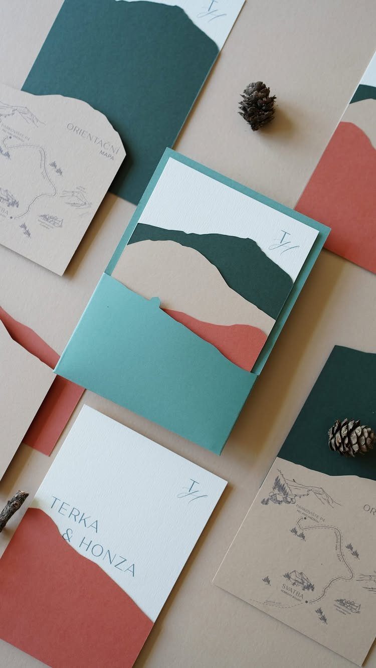 Wedding stationery cards with abstract mountain silhouettes and pine cones on neutral background