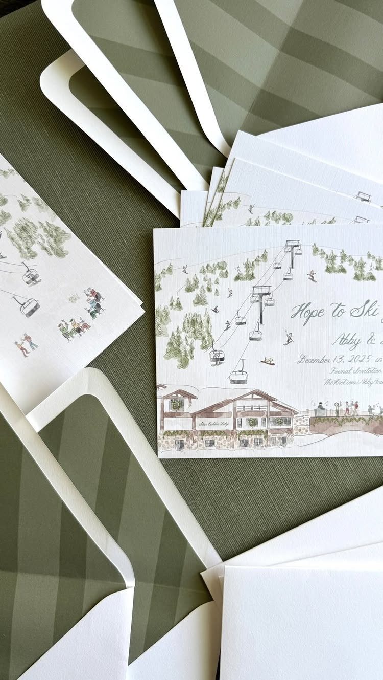 Wedding save the date cards featuring a ski resort illustration and green envelopes.