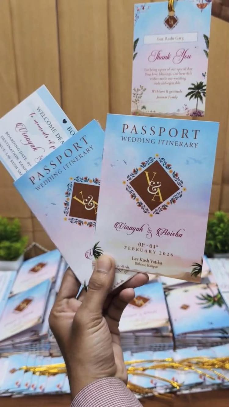 Passport style wedding itinerary cards held in a hand with floral designs.