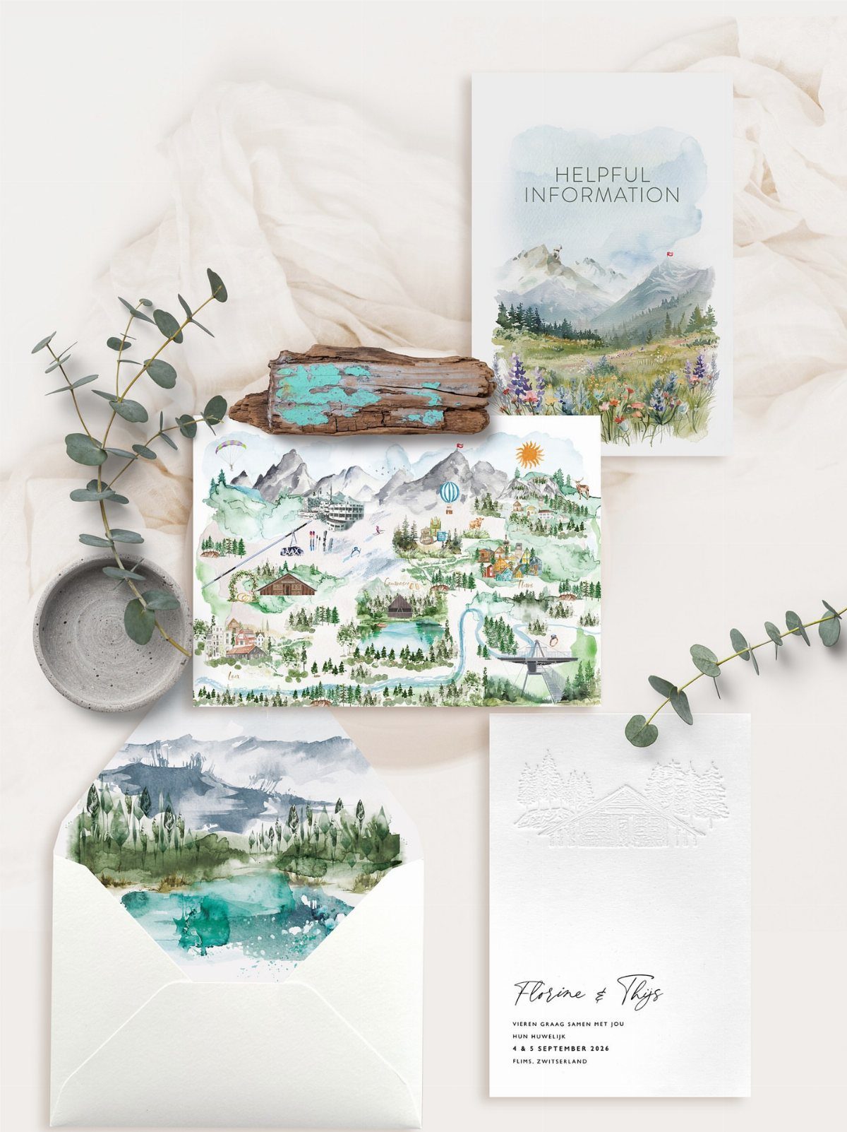 Wedding stationery suite with watercolor mountain landscapes, a map, and eucalyptus leaves.