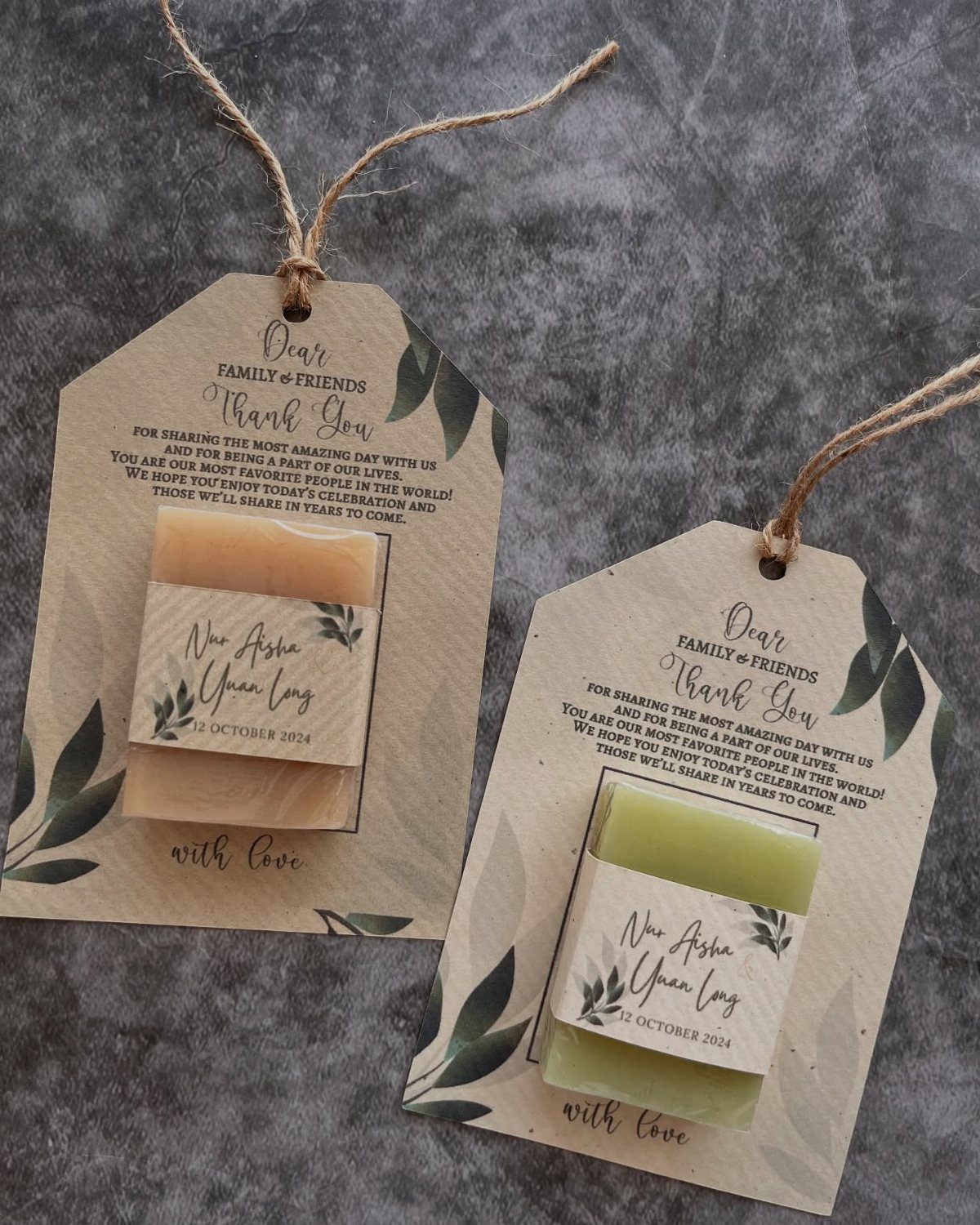 Handmade bar soaps wrapped in paper bands and attached to kraft gift tags.