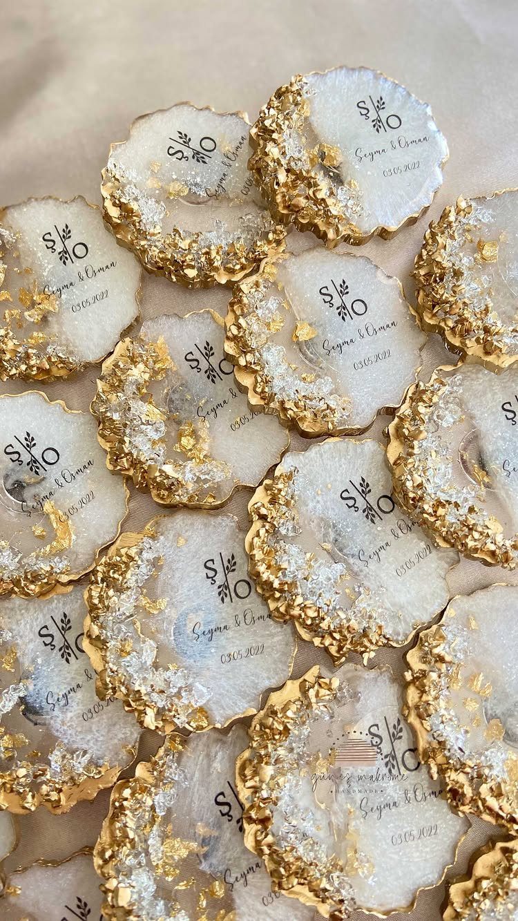 White agate coasters with gold edges and personalized black text on fabric.