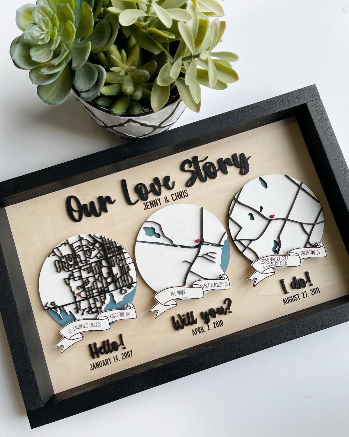 Custom map plaque in a black frame showing three relationship milestones with dates.