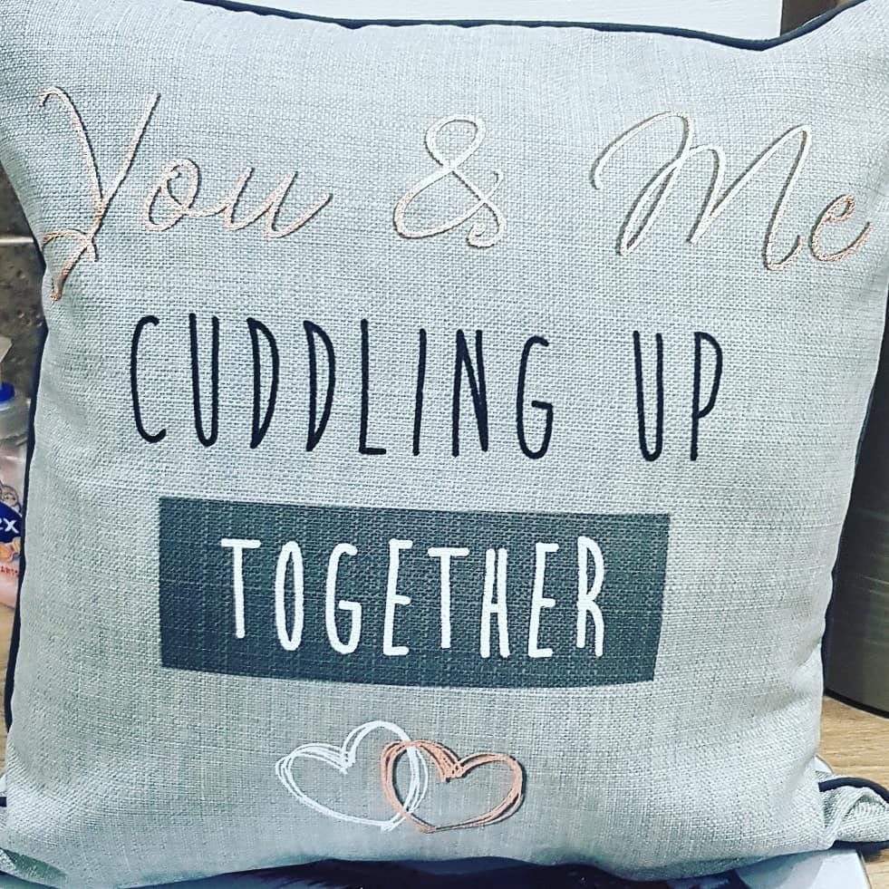 Grey textured pillow with romantic text and interlocking hearts for a couple.