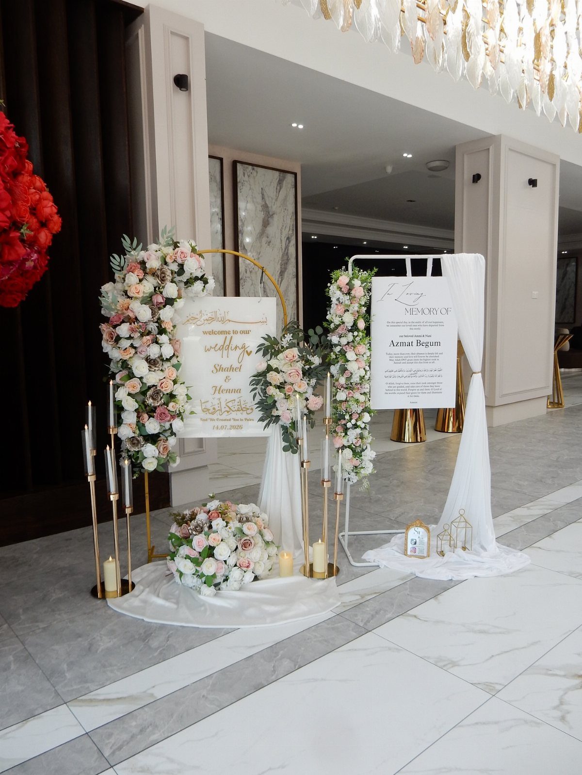 Wedding memory sign on an easel with white fabric and floral arrangements.