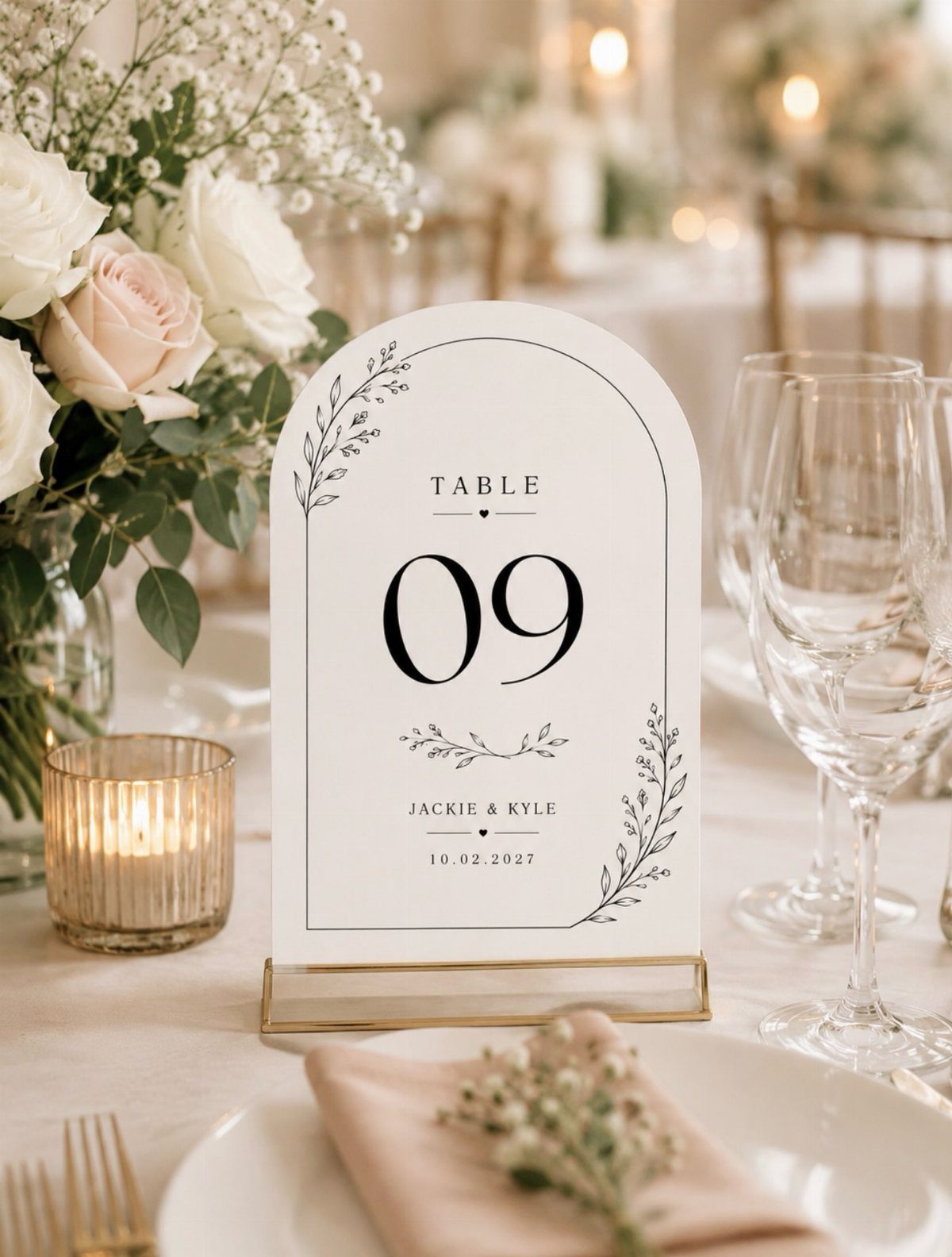 Arched white table number sign 09 on a wedding table with white roses.
