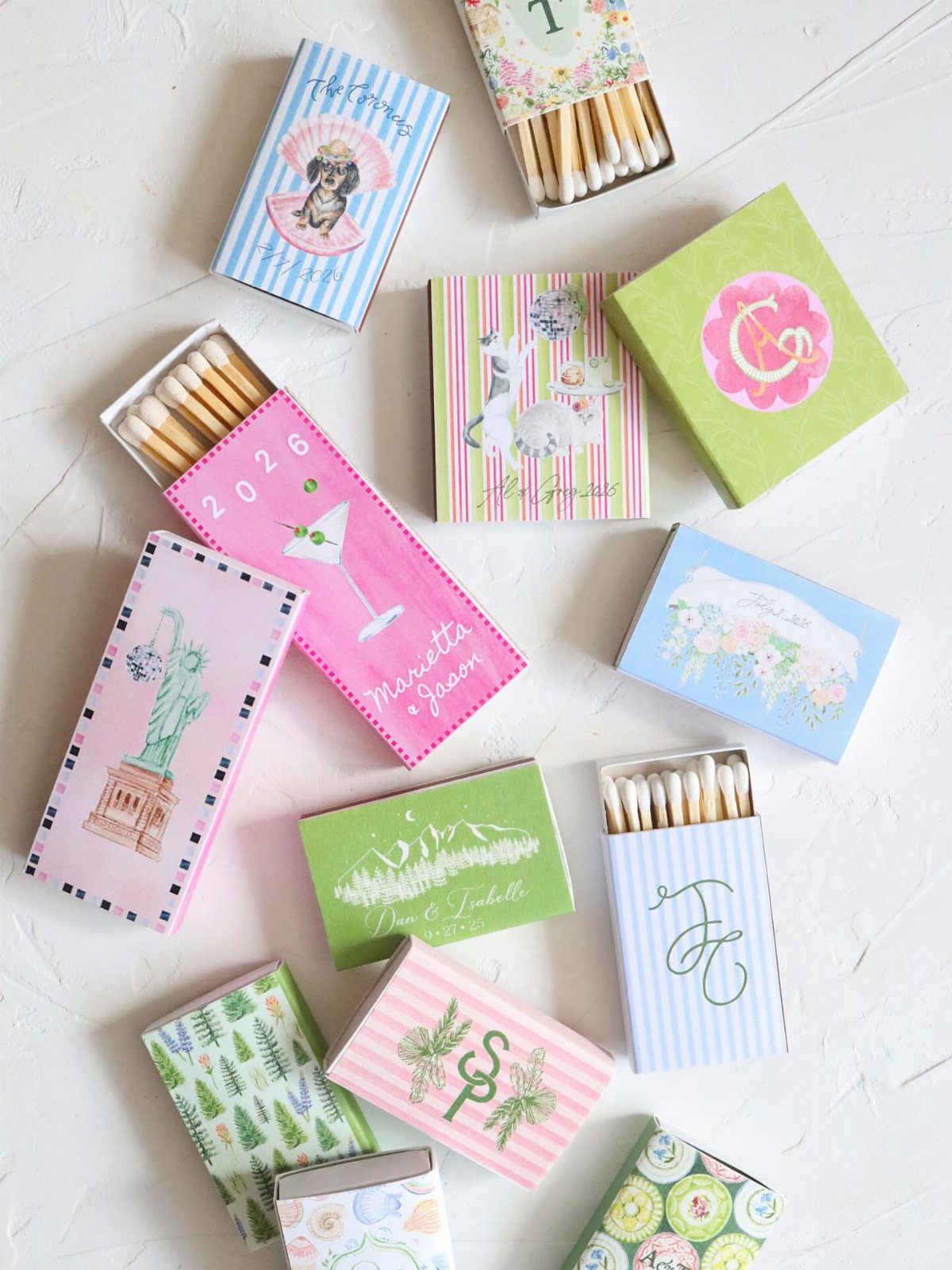 Assorted personalized matchboxes with colorful designs and names on a white background.