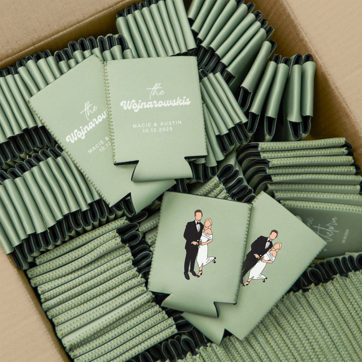 Sage green personalized koozies with wedding names and illustrations in a cardboard box.