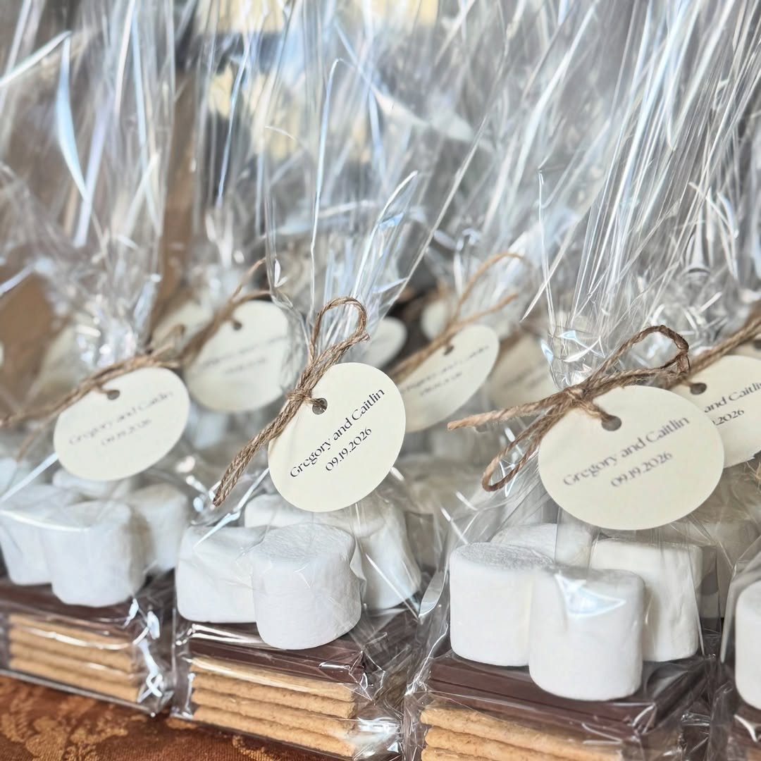 S'mores kits in clear bags with twine and personalized tags for wedding favors.