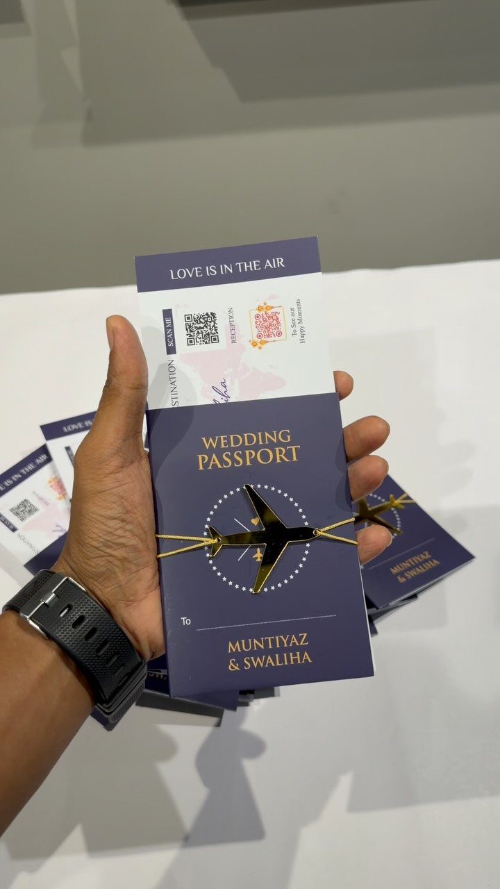 Navy blue passport-style wedding invitation with a gold airplane cutout and boarding pass.