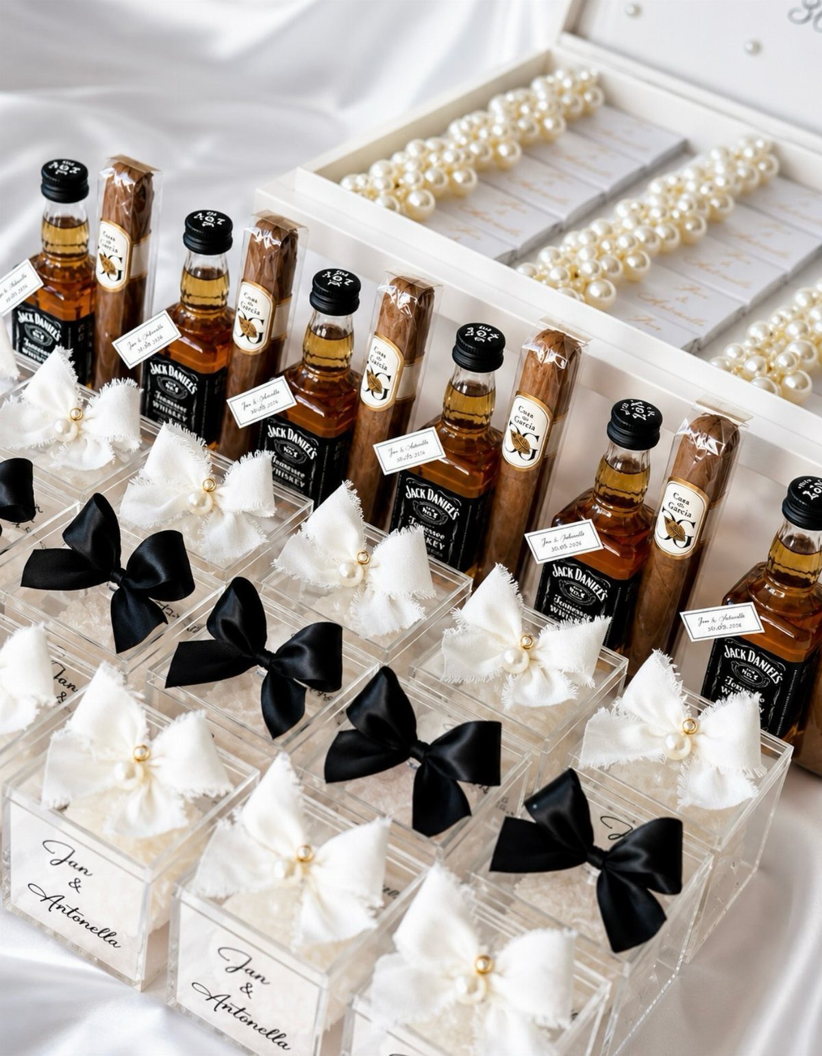 Mini whiskey bottles and cigars in gift boxes with elegant black and white bows.