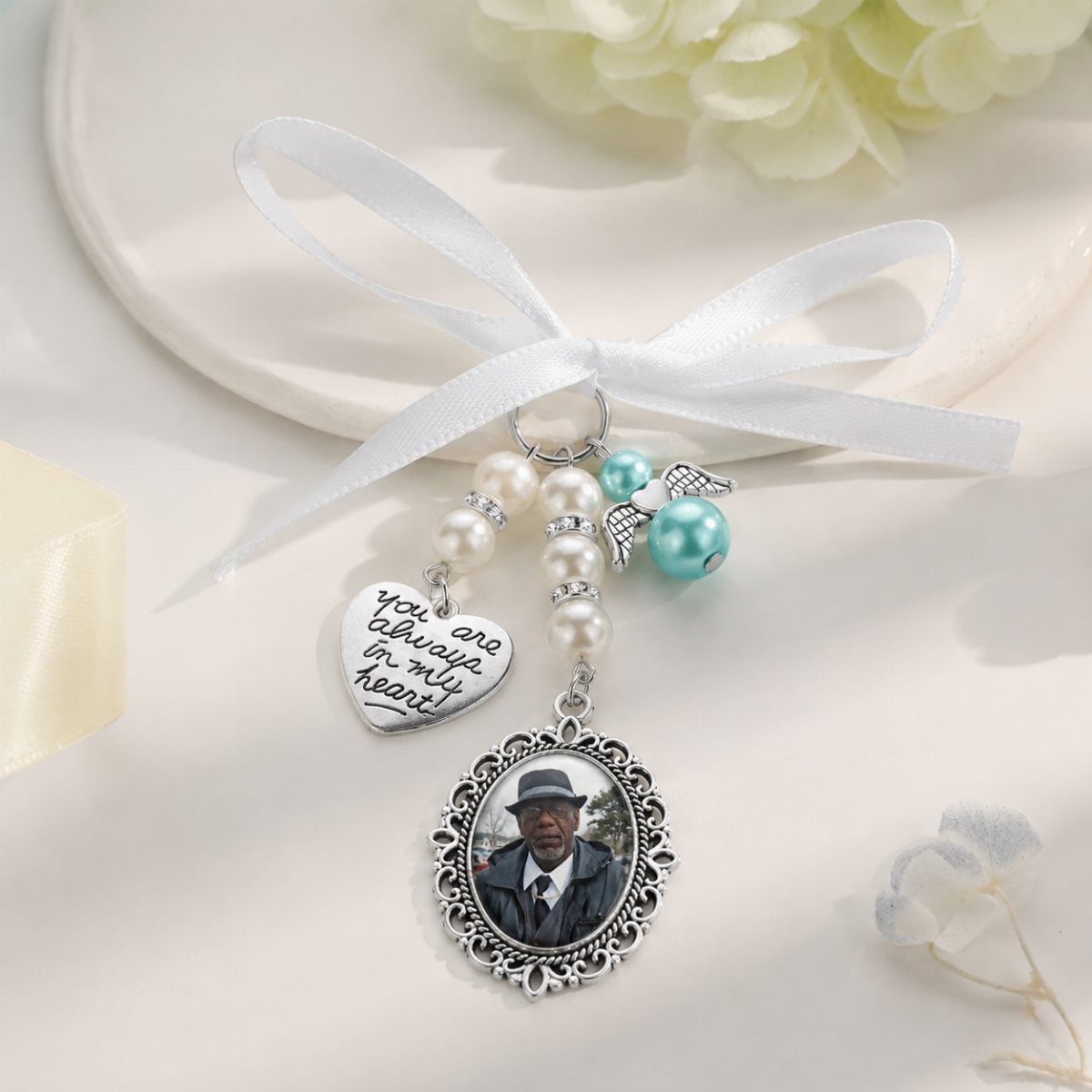 Memorial wedding charm with pearls, a heart pendant, and a framed portrait photo.
