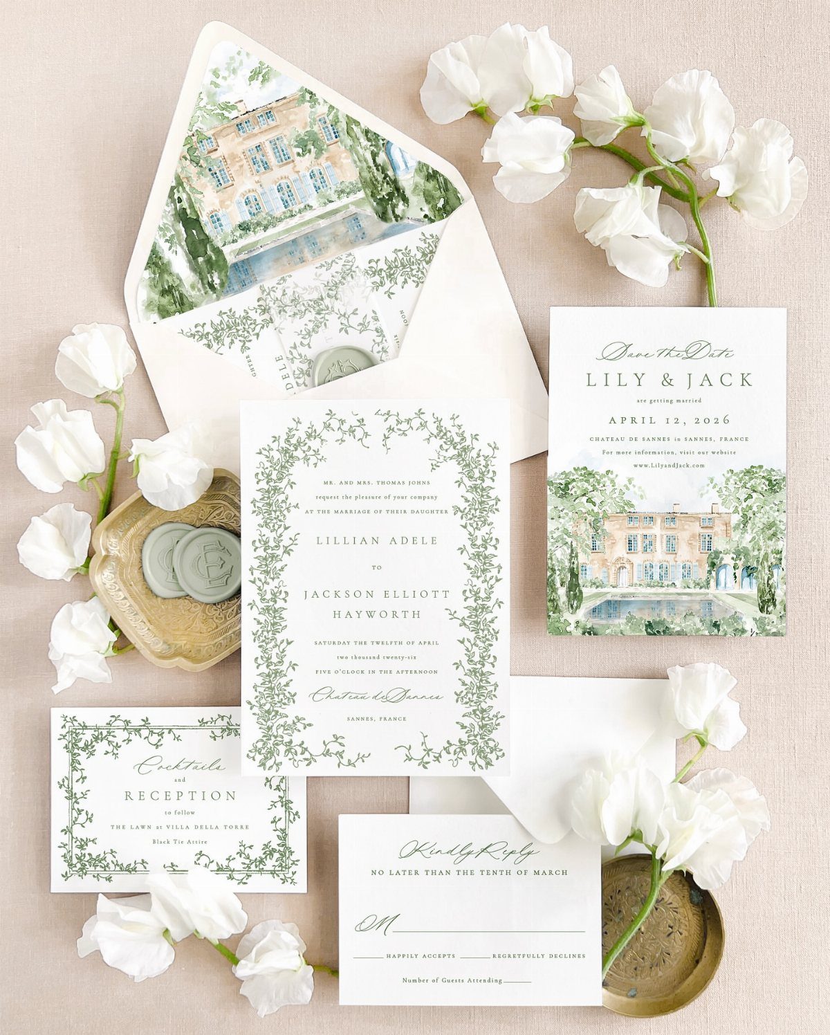 Wedding invitation suite with green botanical borders, watercolor manor house, and white flowers.
