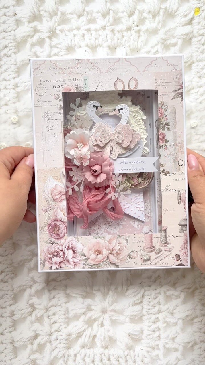 Handmade wedding card with paper collage frame and 3D paper swans and flowers.