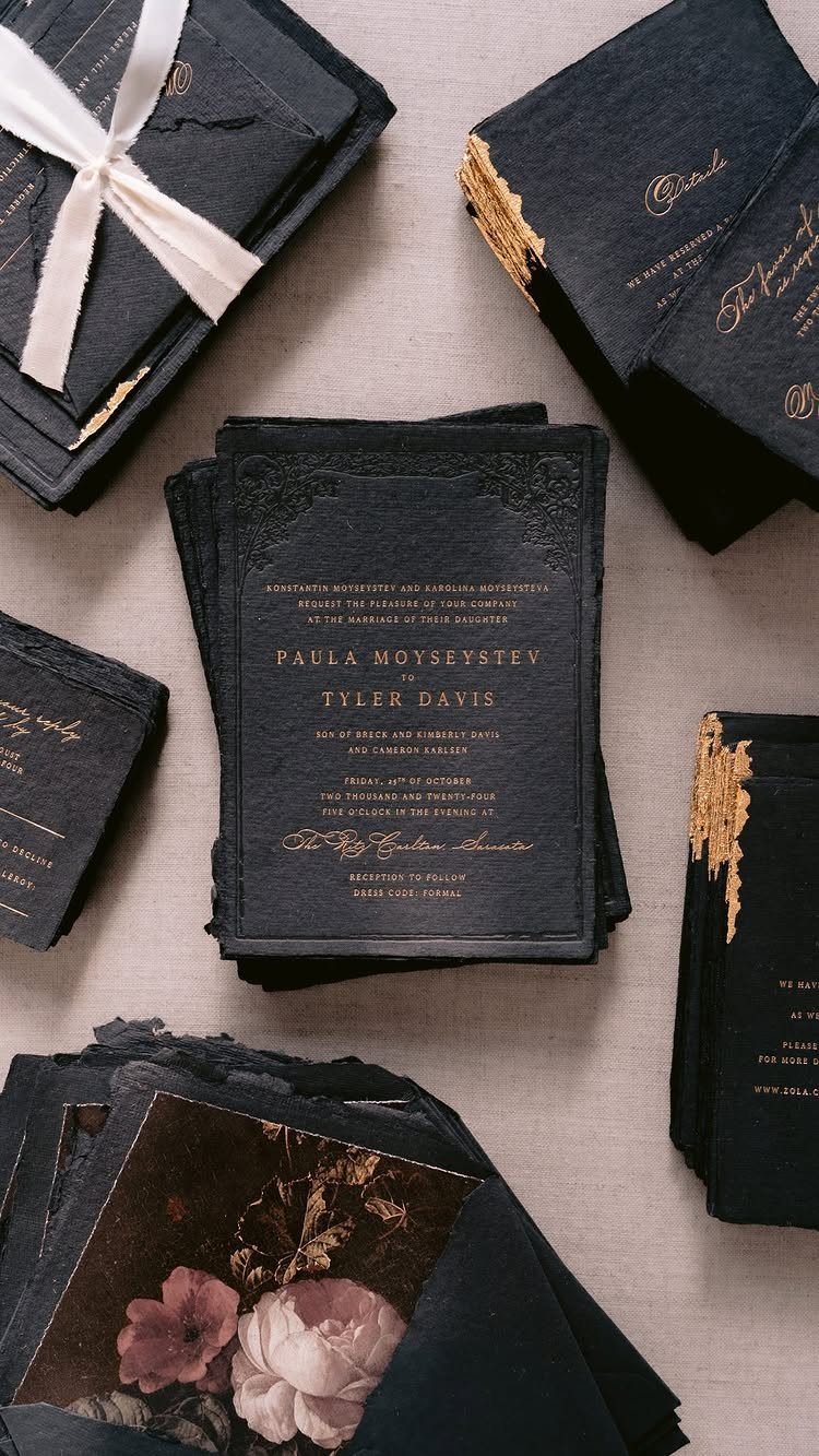 Dark navy wedding invitation suite with gold foil lettering and embossed details.
