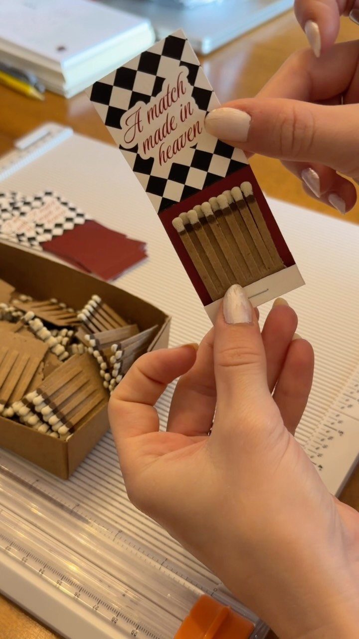 Custom matchbook with 'A match made in heaven' text held by two hands.