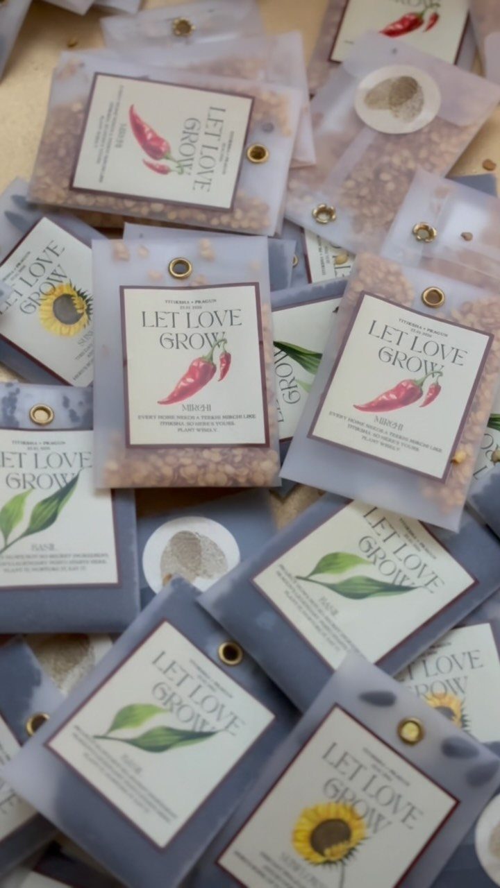 Seed packets with Let Love Grow labels and botanical illustrations for wedding favors.