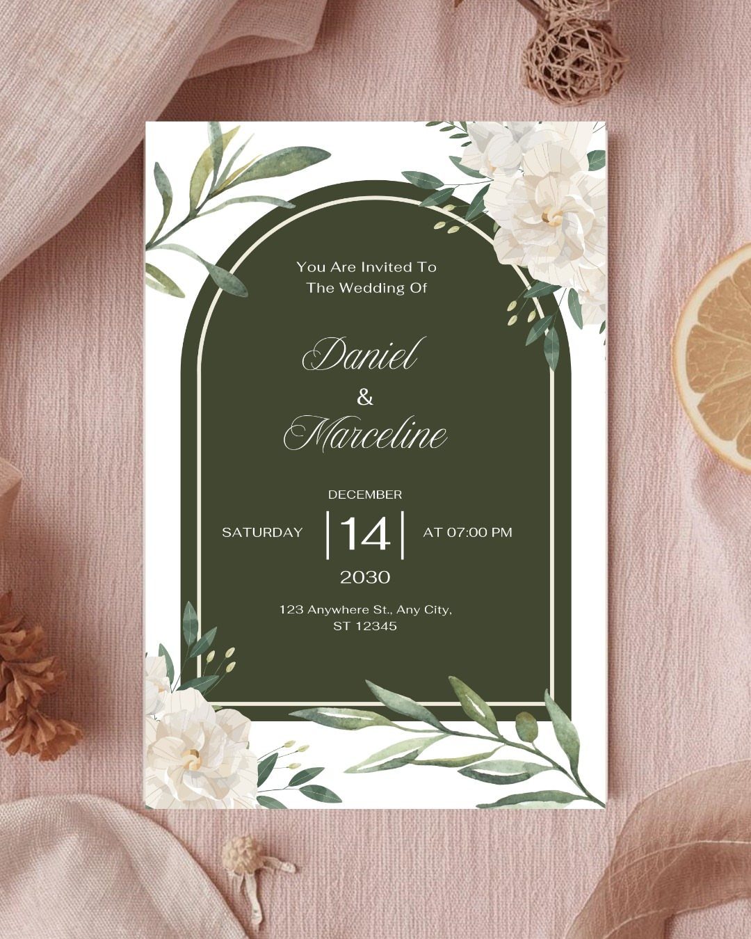 Wedding invitation with white roses and green eucalyptus leaves around a dark green arch.