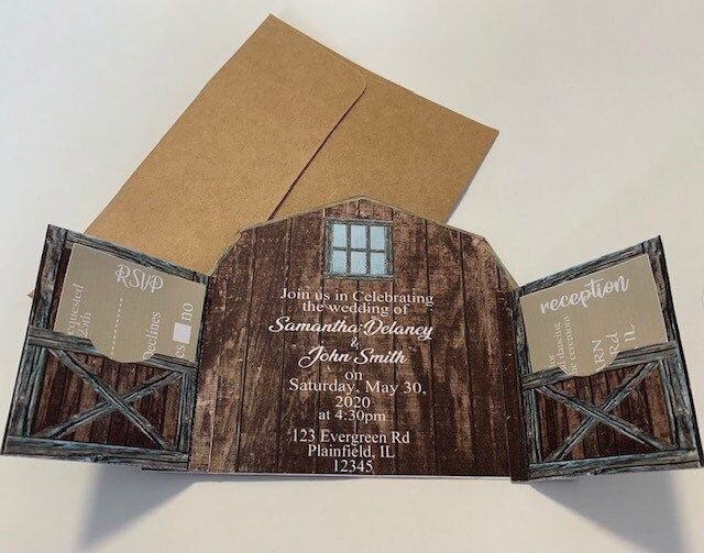 Barn door wedding invitation with wooden texture and brown kraft paper envelopes.