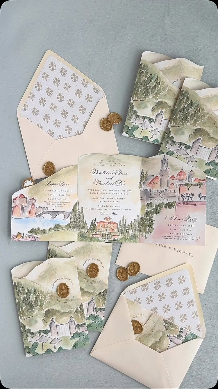 Watercolor illustrated wedding invitations featuring European landscapes and buildings with gold wax seals.