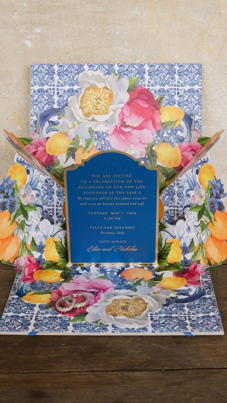 Pop-up wedding invitation with 3D floral and lemon cut-outs and blue tile patterns.