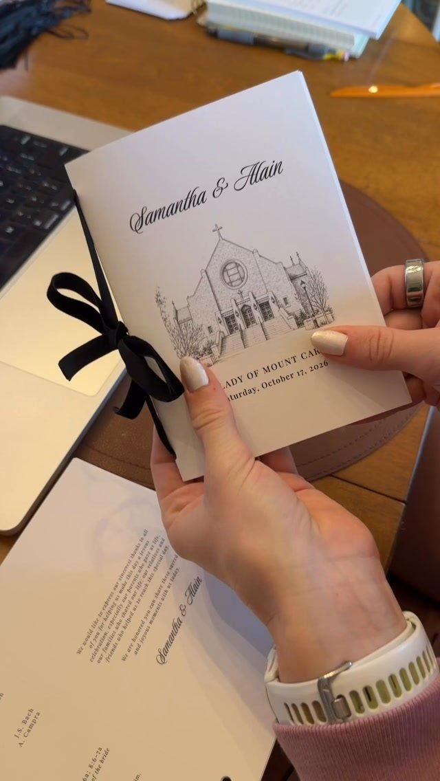 White folded wedding ceremony program with a church illustration and black ribbon bow.