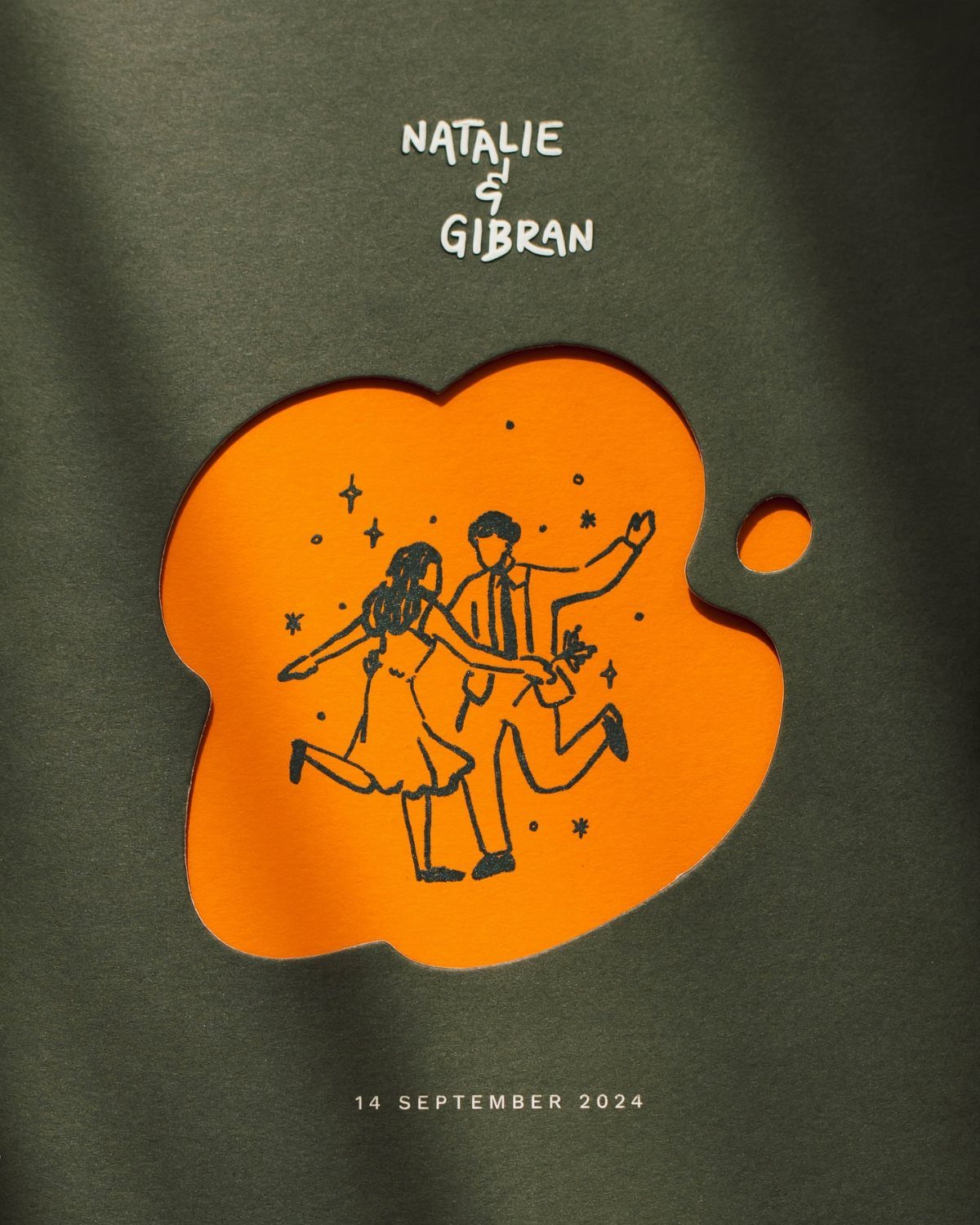 Green wedding invitation with an orange cutout featuring a dancing couple line drawing.